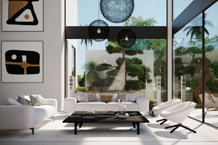 Lounge with white Arketipo sofas and black ash Poliform coffee tables complemented by the spherical lights and wall art that gives the space a subtle ethnic feel.