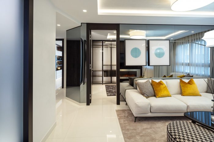 Behind the lounge area you see a glimpse of the walk-in wardrobe
