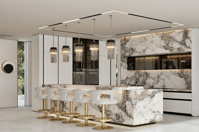 The Art Deco lamps fit in perfectly with the symmetry of the kitchen, as do the five armchair-style high stools.